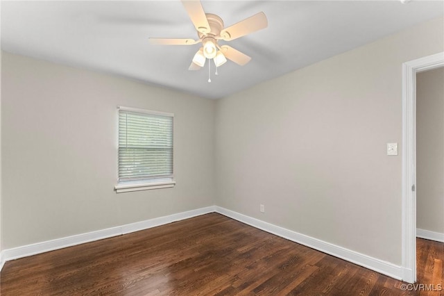 empty room with dark wood finished floors, baseboards, and ceiling fan