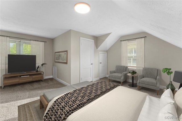carpeted bedroom featuring vaulted ceiling and baseboards