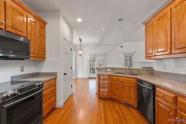11107 Lyndenwood Dr, Chesterfield, VA 23838 - kitchen with brown cabinets, appliances with stainless steel finishes, and a sink