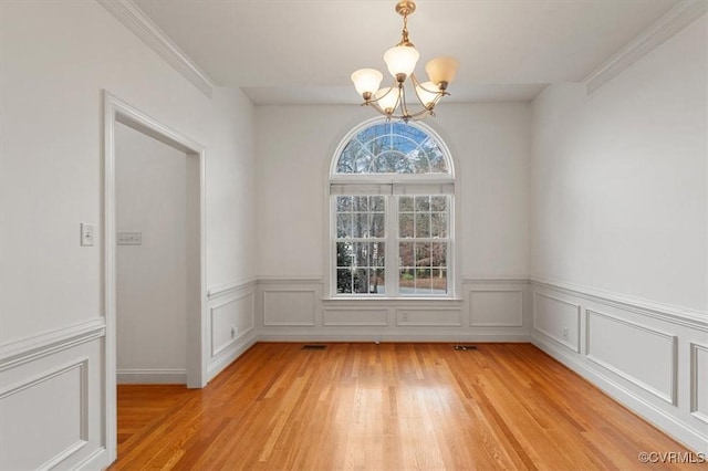 11107 Lyndenwood Dr, Chesterfield, VA 23838 - unfurnished dining area with ornamental molding, light wood finished floors, a notable chandelier, and wainscoting