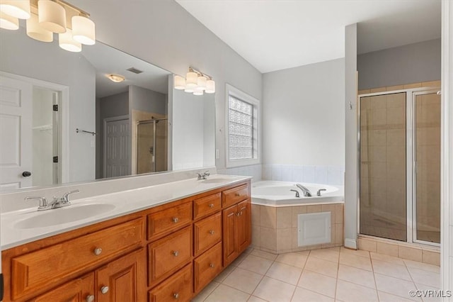 11107 Lyndenwood Dr, Chesterfield, VA 23838 - full bathroom featuring tile patterned floors, a sink, a stall shower, visible vents, and a garden tub
