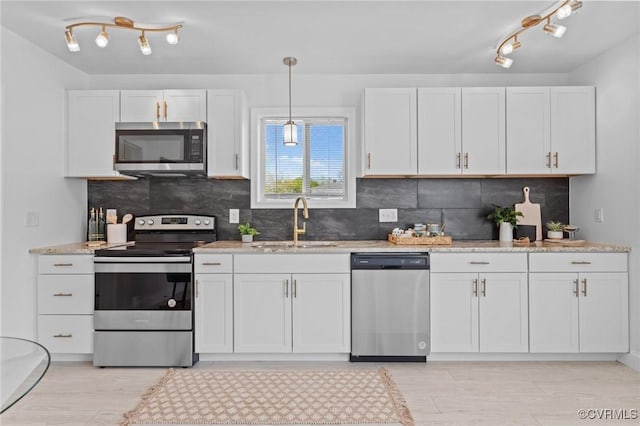 6512 River Rd, South Chesterfield, VA 23803 - kitchen featuring white cabinets, appliances with stainless steel finishes, a sink, and light wood-style floors