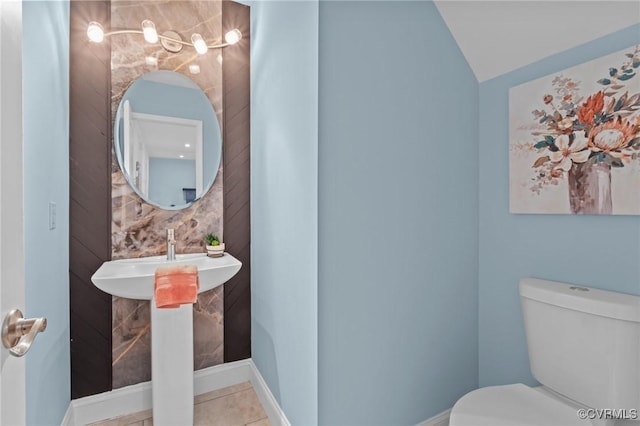 6512 River Rd, South Chesterfield, VA 23803 - bathroom featuring toilet, lofted ceiling, and tile patterned flooring