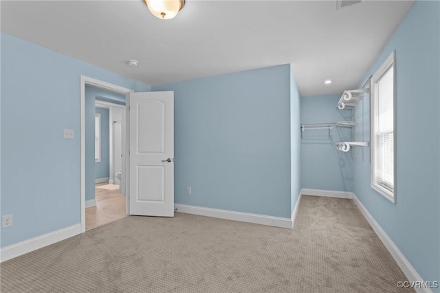 6512 River Rd, South Chesterfield, VA 23803 - unfurnished bedroom featuring a spacious closet, baseboards, carpet, and a closet