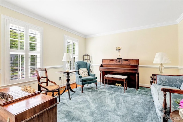 living area with baseboards and ornamental molding