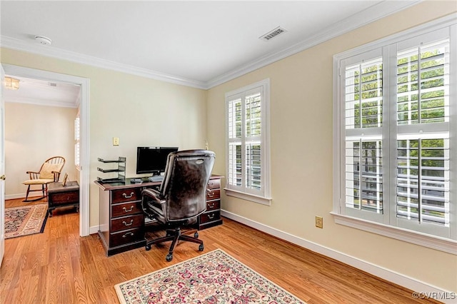 office featuring baseboards, ornamental molding, wood finished floors, and visible vents