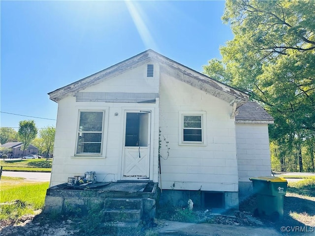 rear view of house with roof with shingles