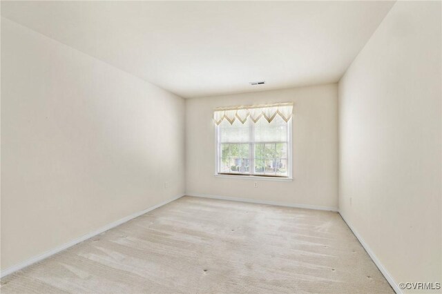 carpeted empty room with baseboards and visible vents