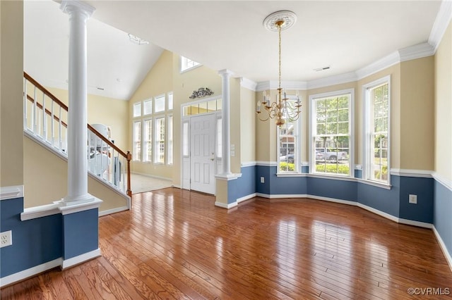 entrance foyer featuring a wealth of natural light, baseboards, hardwood / wood-style floors, and stairs