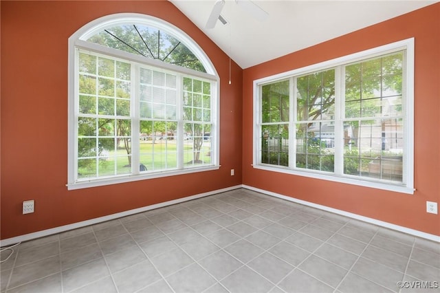 spare room featuring vaulted ceiling, baseboards, and ceiling fan