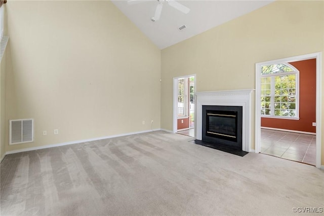 unfurnished living room featuring carpet flooring, baseboards, high vaulted ceiling, and visible vents