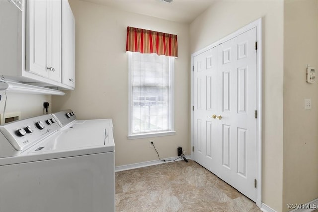 laundry room with washer and clothes dryer, cabinet space, and baseboards