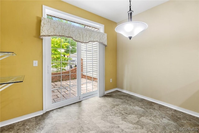 unfurnished dining area featuring baseboards