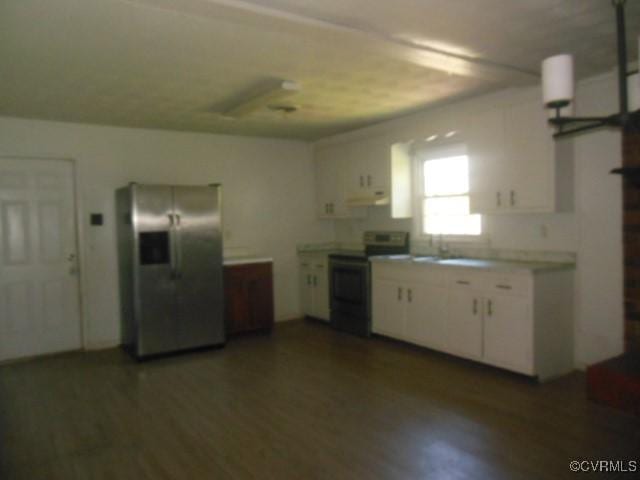 kitchen featuring wood finished floors, white cabinetry, light countertops, appliances with stainless steel finishes, and ventilation hood