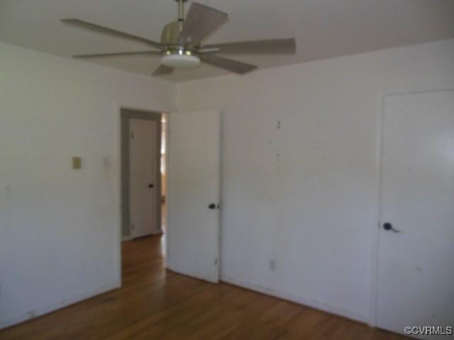 empty room featuring wood finished floors and ceiling fan