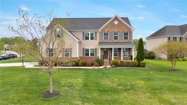 view of front facade featuring a porch, brick siding, and a front lawn