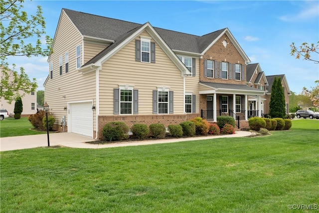 view of front of house with brick siding, driveway, a garage, a front yard, and covered porch