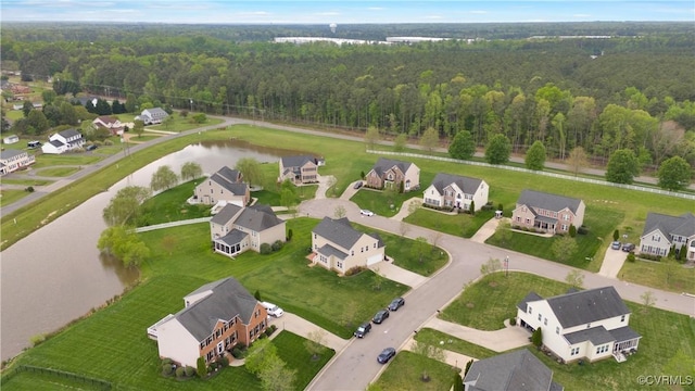 aerial overview of property's location featuring a large body of water, a heavily wooded area, and nearby suburban area