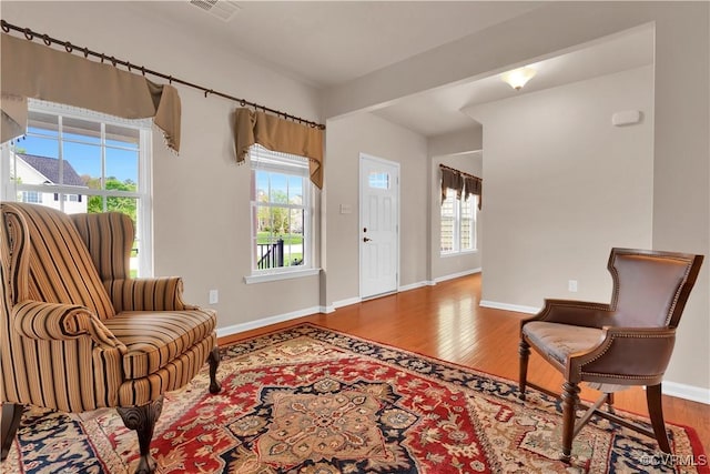 living area with wood finished floors and baseboards
