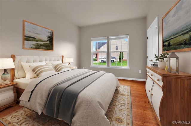 bedroom with light wood-style flooring and baseboards
