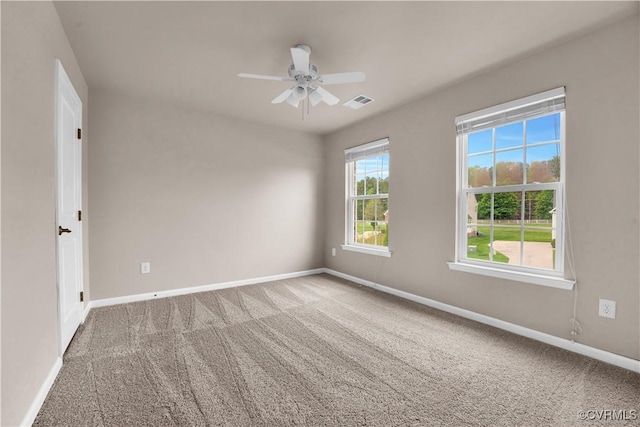 empty room with baseboards, carpet, and ceiling fan