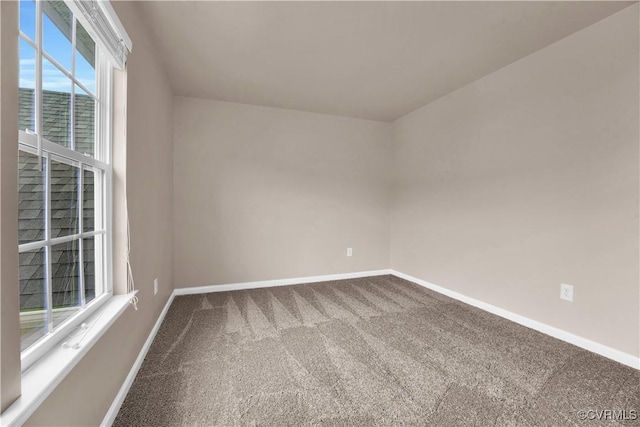 carpeted spare room with baseboards