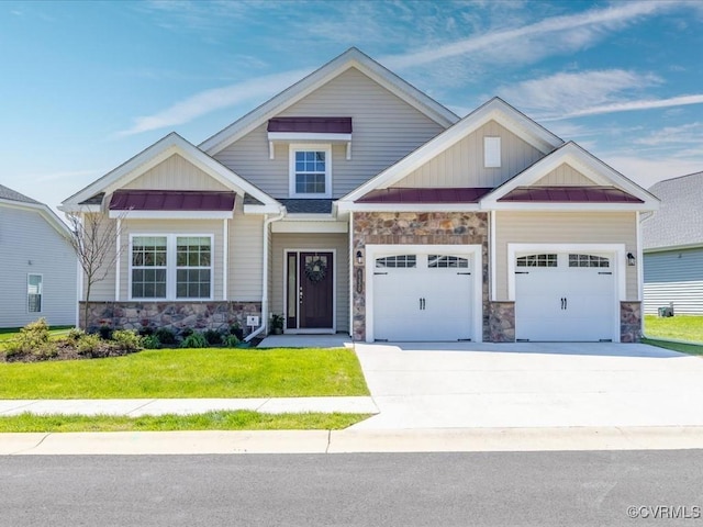 craftsman inspired home featuring an attached garage, a standing seam roof, driveway, stone siding, and metal roof