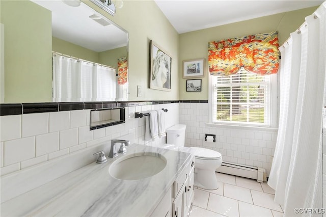 full bathroom featuring tile walls, vanity, tile patterned floors, a baseboard heating unit, and toilet