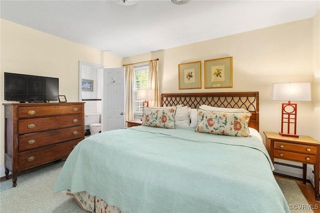 bedroom with carpet, baseboards, and baseboard heating