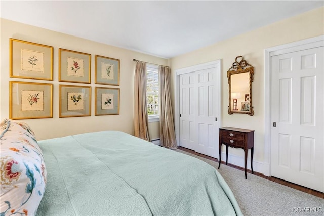 bedroom featuring a closet and a baseboard heating unit