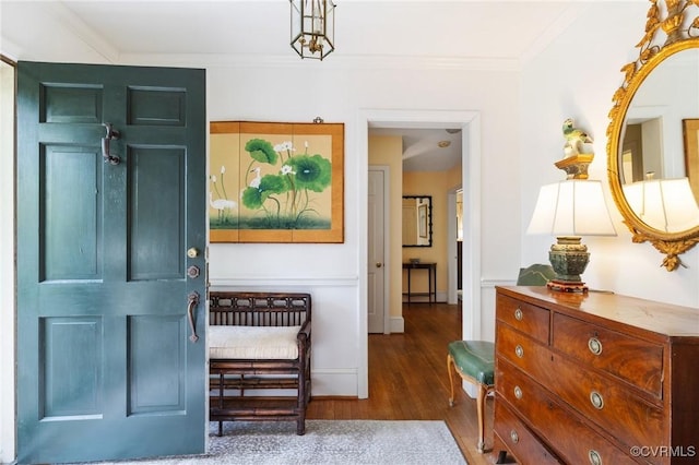 entrance foyer with ornamental molding and wood finished floors