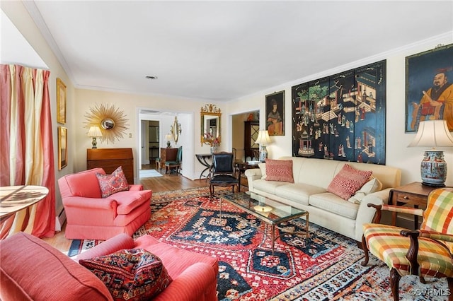 living room featuring ornamental molding and wood finished floors