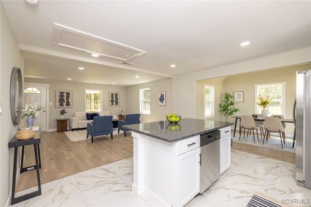 kitchen featuring dark stone countertops, marble finish floor, stainless steel appliances, white cabinetry, and recessed lighting