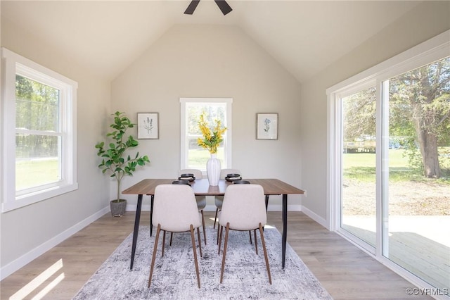 dining space featuring lofted ceiling, light wood-style flooring, and ceiling fan