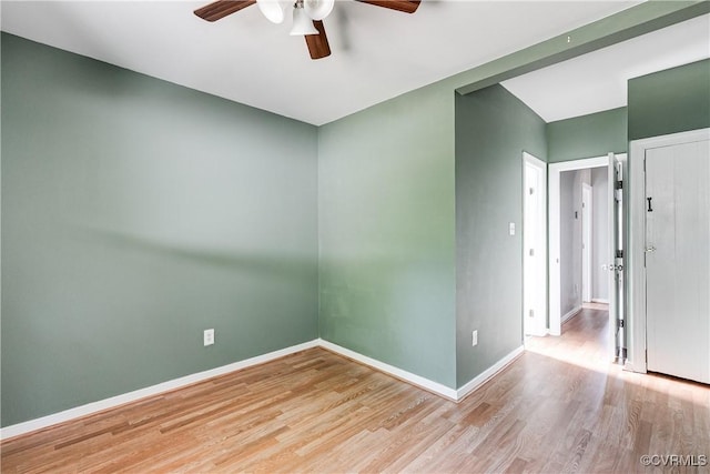 spare room with a ceiling fan, baseboards, and wood finished floors