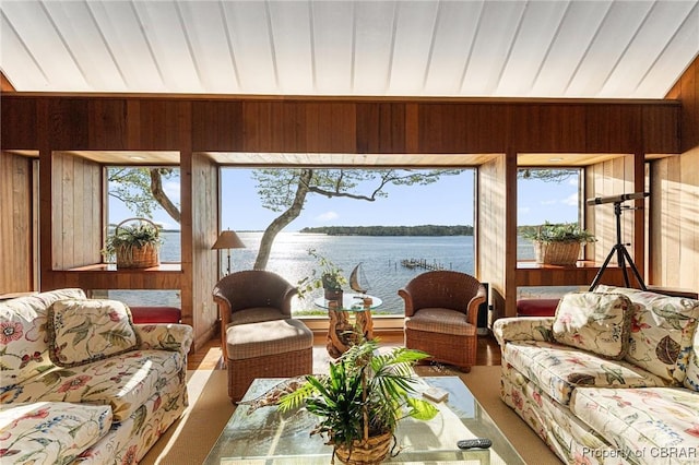 living room with wood walls and a water view