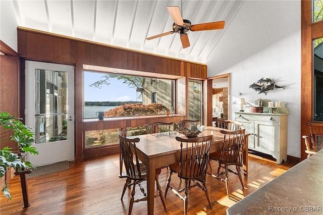 dining space with vaulted ceiling, wood finished floors, and ceiling fan