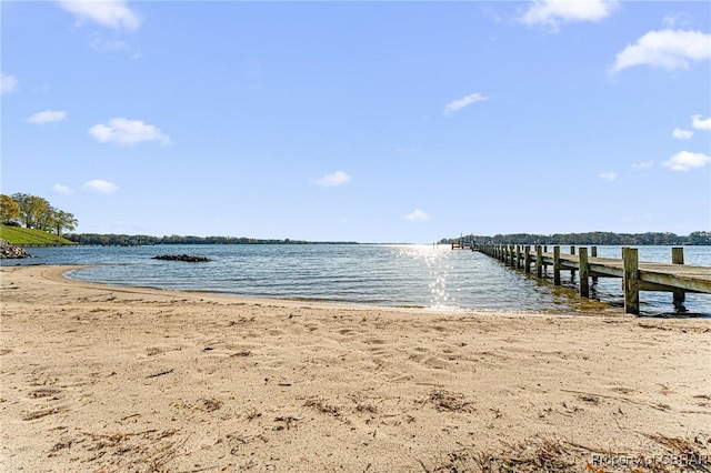 dock area featuring a view of the beach and a water view