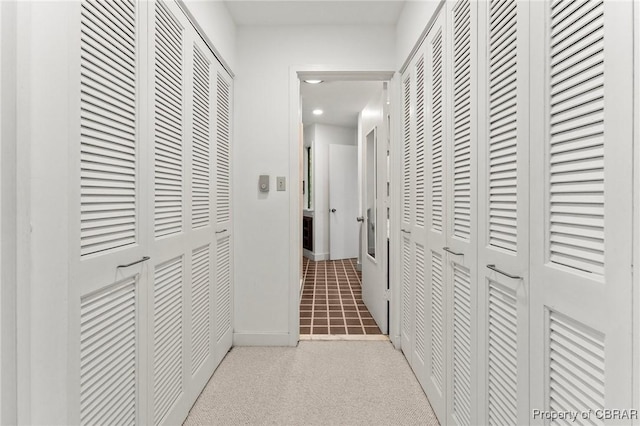 hallway with carpet floors, baseboards, and recessed lighting