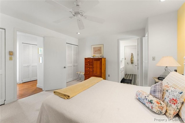 carpeted bedroom with ensuite bath, recessed lighting, and ceiling fan