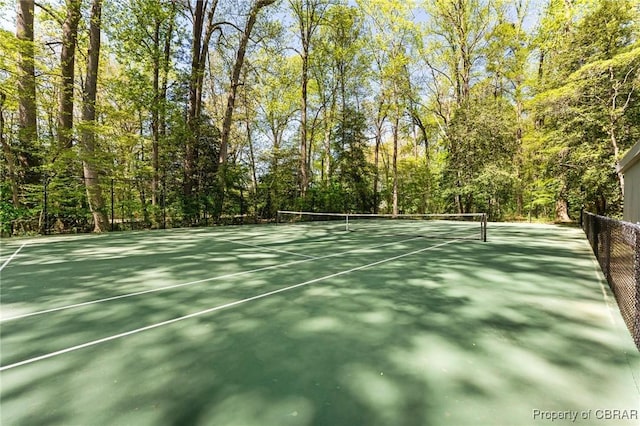 view of sport court featuring fence