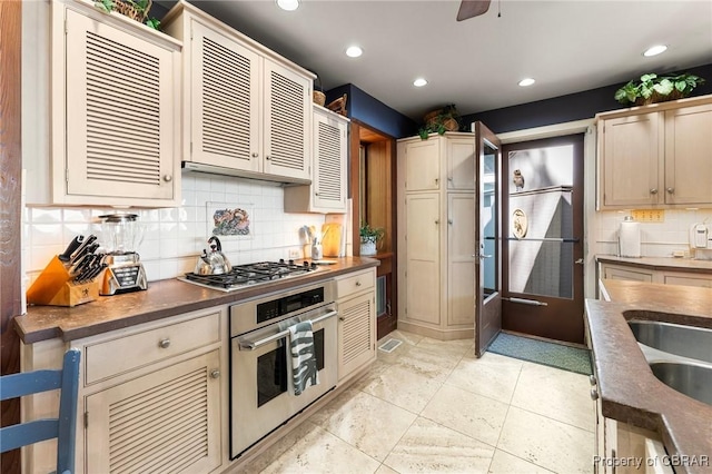 kitchen with decorative backsplash, dark countertops, stainless steel appliances, and recessed lighting