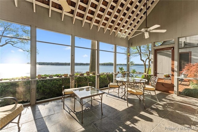 sunroom / solarium featuring a wealth of natural light, a water view, and ceiling fan