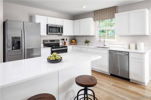 4140 Courthouse Rd, Prince George, VA 23875 - kitchen with stainless steel appliances, a sink, a kitchen breakfast bar, white cabinetry, and light countertops