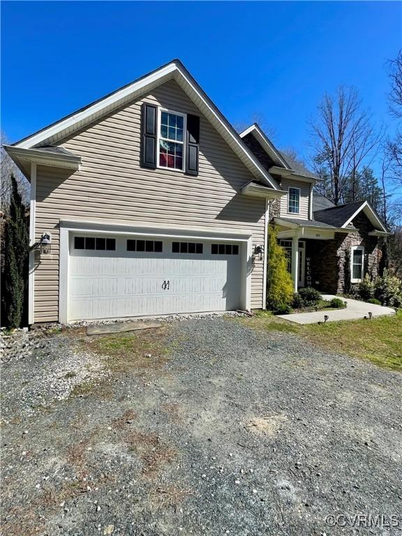 view of side of home with an attached garage and driveway
