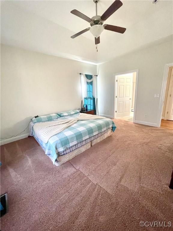 carpeted bedroom with baseboards and a ceiling fan