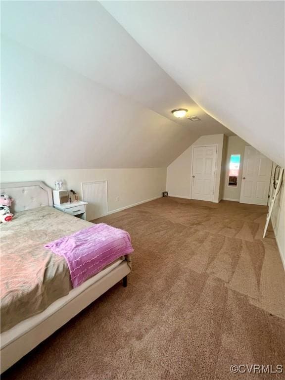 bedroom with light carpet, lofted ceiling, and baseboards