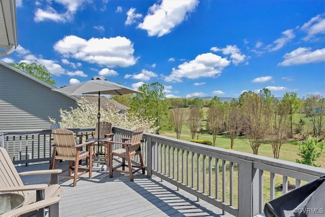 wooden terrace with outdoor dining area