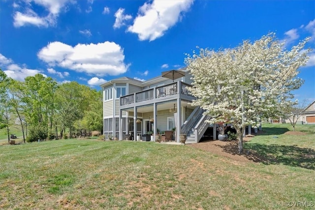 rear view of property featuring stairs, a yard, and a deck