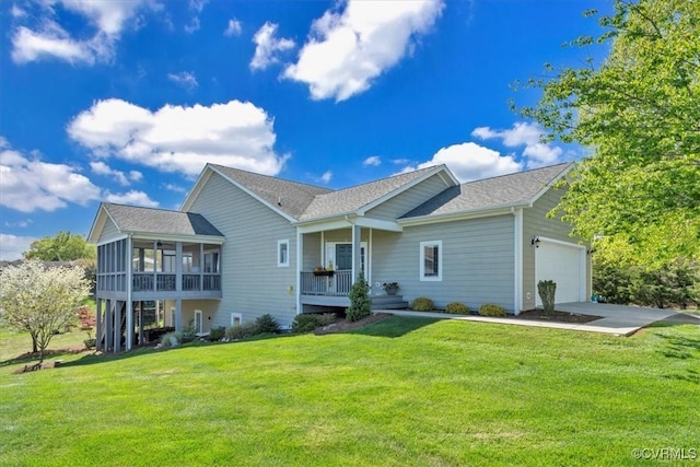 ranch-style home with a shingled roof, a garage, a sunroom, a front yard, and driveway